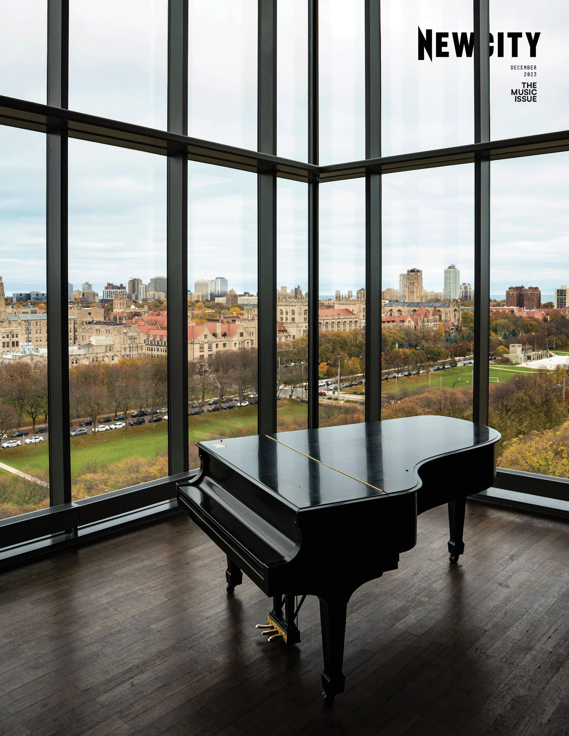 A grand piano sits in front of floor-to-ceiling windows overlooking a cityscape and green park on an overcast day, evoking the rich heritage of Chicago music. The cover features the NEWCITY magazine logo in the upper right corner and showcases the December 2023 Issue: The Music Issue (Print Edition).