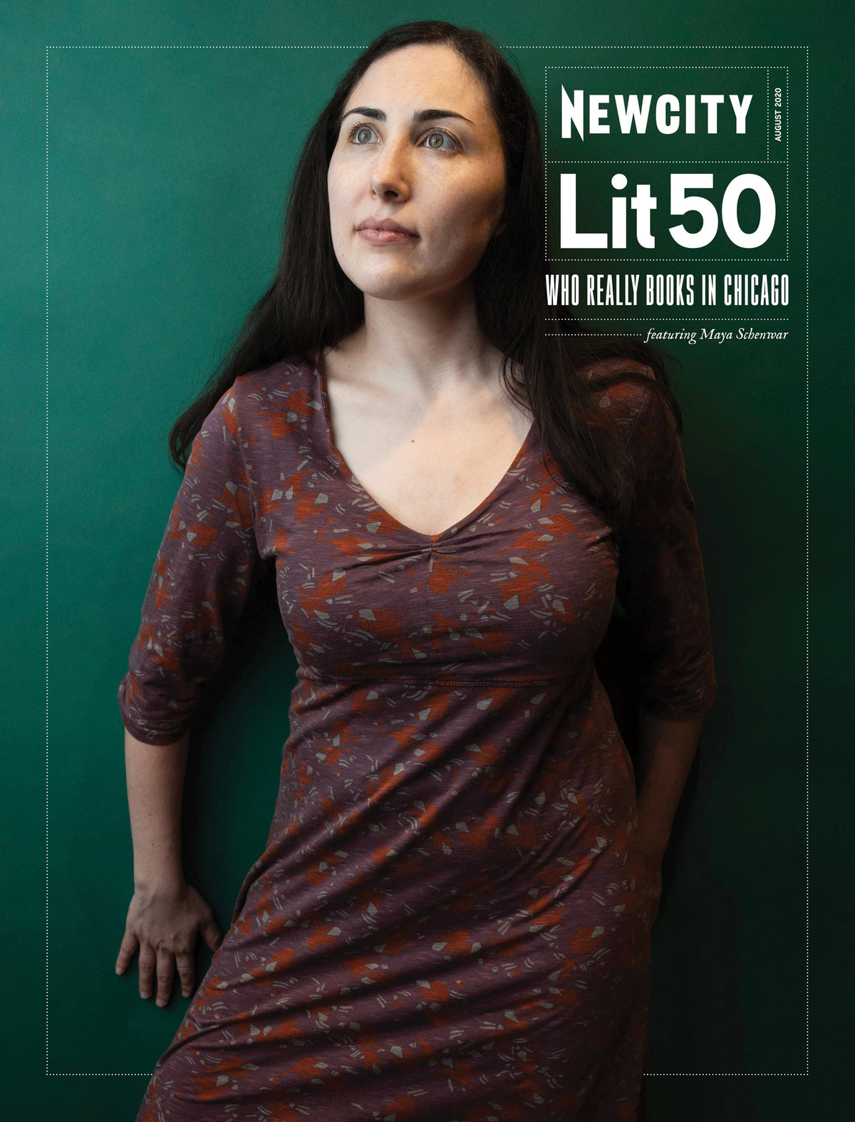 A woman with long dark hair poses against a green background on the cover of the August 2020 Issue: Lit 50. She wears a patterned maroon dress and gazes thoughtfully to the side, embodying the creative spirit of Chicago writers whose voices resonate from Lake Michigan throughout the city.