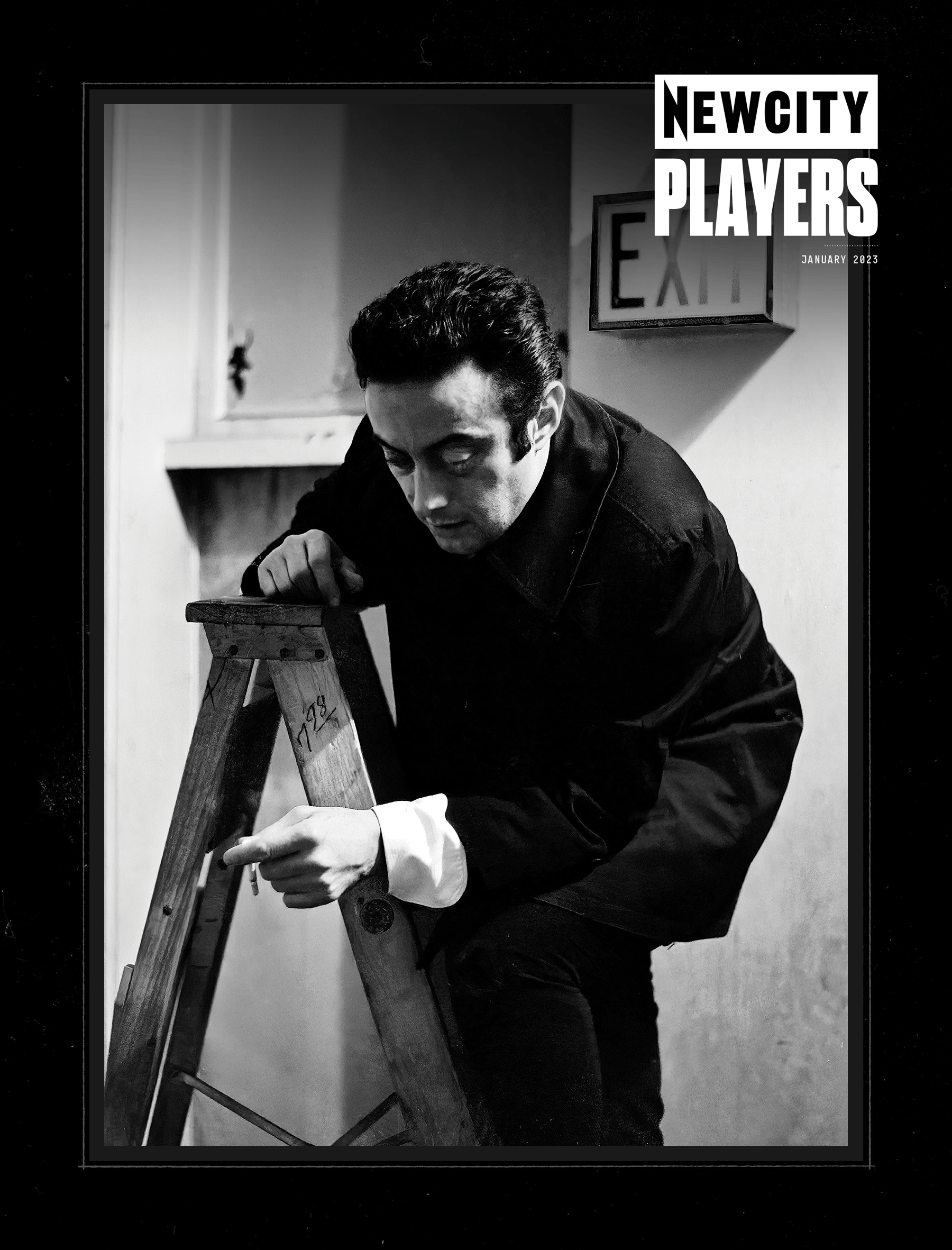 A person dressed in dark clothing—possibly styled by a wardrobe stylist—climbs a wooden ladder indoors, looking down and pointing, with an EXIT sign visible on the wall behind them. The black and white image features the text "NEW CITY PLAYERS" and appears in the January 2023 Issue: Players 50 (Print Edition).