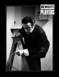 A person in dark clothing, styled by a wardrobe stylist, crouches on a wooden ladder while holding a cigarette, beneath an EXIT sign. The image is in black and white, with the words "January 2023 Issue: Players 50 (Digital Edition)" appearing in the top right corner.