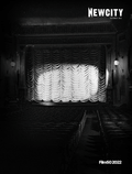 Black and white photo of an empty theater with ornate decor, rows of seats, and a large curtain on stage. The image evokes the timeless elegance celebrated in Field Guide to Photography and Media, curated by Elizabeth Siegel at the Art Institute of Chicago. Featured in the December 2022 Issue: Film 50 (Print Edition) by Newcity.